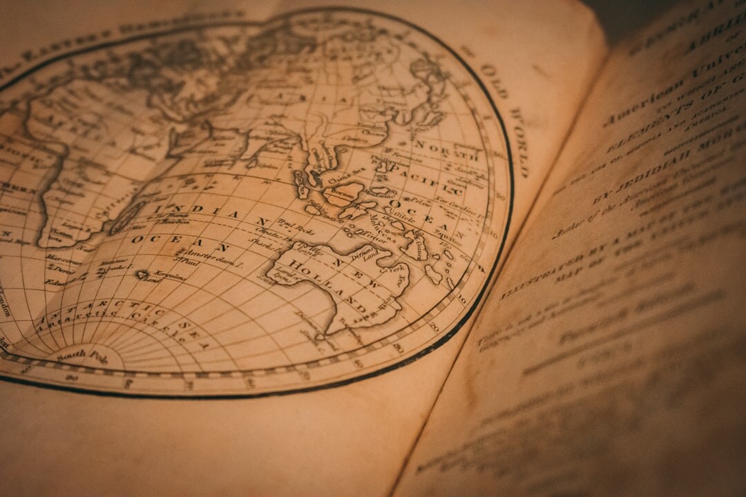 Illustrated mystery book cover with a magnifying glass over an old map