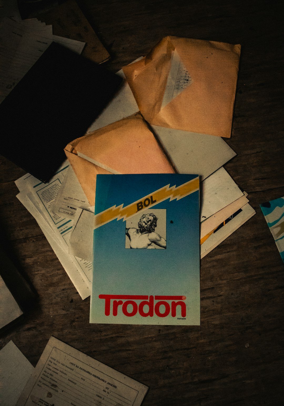 Illustrated mystery book cover with a lit cigarette and a torn letter on a desk